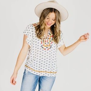 Embroidered cream and multi-colored blouse
